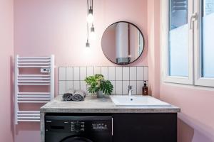 a bathroom with a sink and a washing machine at The New Bliss - Duke Housing in Vitry-sur-Seine