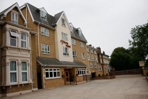 a large brick building with a sign on it at Viking Hotel in London
