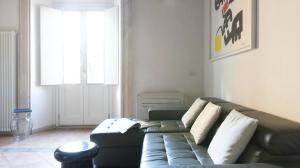a living room with a couch and a window at Pgrhome Luxury Apartments Domus Pantheon in Rome