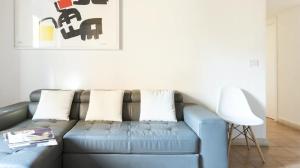 a blue couch sitting in a living room at Pgrhome Luxury Apartments Domus Pantheon in Rome