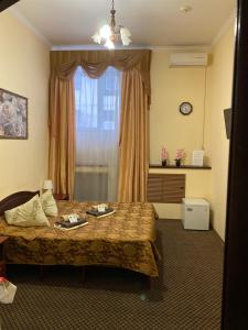 a bedroom with a bed and a dresser at Hotel Safyan in Kazan