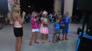 a group of children standing on a dance floor at Camping Le Mas Sud Ardèche in Saint-Just