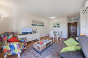a living room with two couches and a table at Apartment Corb Mari in Port de Pollensa