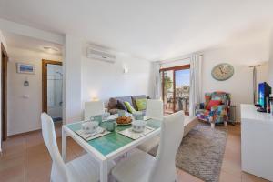 a dining room and living room with a table and chairs at Apartment Corb Mari in Port de Pollensa