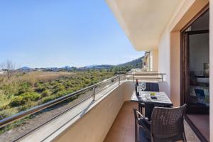 a balcony with a table and chairs and a view at Apartment Corb Mari in Port de Pollensa