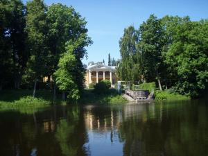 a house sitting on the side of a lake at Räpina Apartment in Räpina