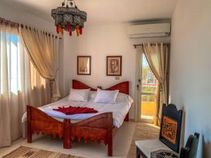 a bedroom with a bed and a chandelier at Royal Suite on The Touristic Promenade in Hurghada