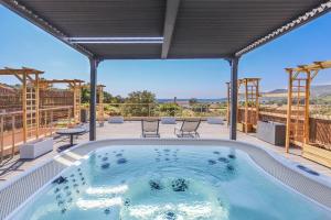 a hot tub on the patio of a house at Camping maeva Escapades Le Colomba in Olmeto
