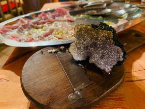 a plate of food on a table with a pizza at Agri BERTORELLA in Torre Bormida