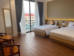 Kama o mga kama sa kuwarto sa Thanh Bình Hotel - 47 Y Bih - BMT