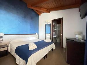 a bedroom with a large bed with towels on it at Il Belvedere Guest House in Scalea