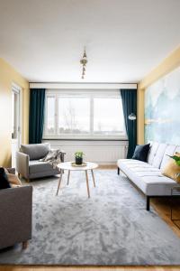 a living room with a couch and a table at 2 Bedroom apartment with free parking in Kuopio