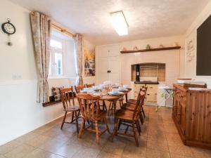 a kitchen and dining room with a table and chairs at The Vale in Beaworthy