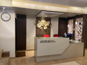 a restaurant with a clock on the wall and a counter at Dash Hotels - Affordable Luxury in Hyderabad