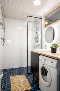 a bathroom with a washing machine and a sink at 2 Bedroom apartment with free parking in Kuopio