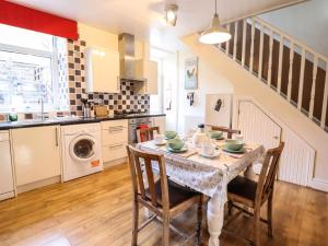 a kitchen and dining room with a table and chairs at The Old Post Office in Betws-y-coed