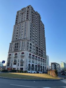 a tall building with cars parked in front of it at City view in Residences in Burgas City