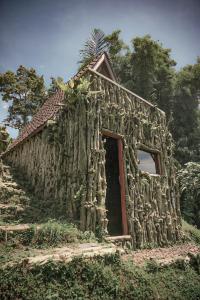 a small stone building with a palm tree on top at KAMPUNG KOPI CAMP in Pujungan