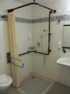 a bathroom with a shower and a toilet and a sink at Hotel A2 in Schopsdorf