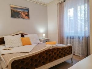 a large bed in a room with a window at Apartments Relax in Rovinj