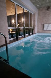 a swimming pool in a hotel with potted plants at Porto Resort in Lilaste