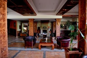 a lobby with chairs and a table and a table at Hotel Centar Balasevic in Belgrade