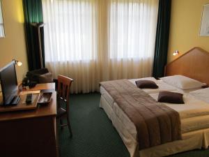 Ένα ή περισσότερα κρεβάτια σε δωμάτιο στο Hotel A2