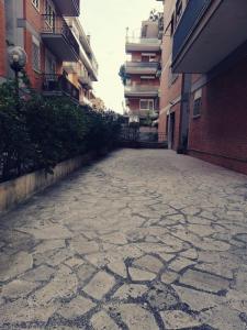 an empty street in an alley between buildings at A&C Talenti Diamond in Rome