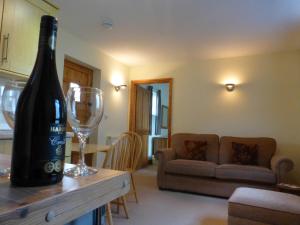 a bottle of wine on a table in a living room at Courtbrook Farm in Exeter