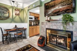 a living room with a fireplace and a dining room at Lovely condo w/ indoor pool *only steps to parkway in Gatlinburg