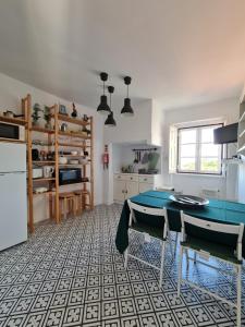 a kitchen with a ping pong table in a room at Maria Saudade - Bright & Spacious Apartment with Views in the Heart of Sintra in Sintra