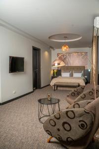 a living room with a bed and a couch at Akacija Luxury Suites in Belgrade