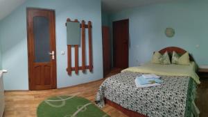 a bedroom with a bed and a wooden floor at Casa Terzea in Râşnov