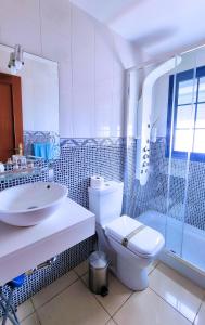 une salle de bain avec toilettes, lavabo et douche dans l'établissement La Graciosa Mykonos Beach, Junior Suite, à Caleta de Sebo 24 autres photos