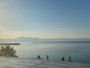 a large body of water with mountains in the background at Fisilanis Beachfront Hotel in Logaras