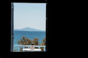 a window with a view of the ocean at Fisilanis Beachfront Hotel in Logaras