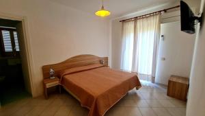 a bedroom with a bed and a large window at Cocos Park Ischia in Ischia