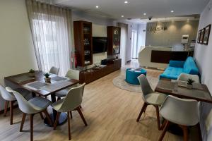 a living room with a table and chairs and a couch at Memória Boutique Hostel in Angra do Heroísmo