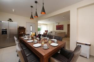 a large wooden table in a living room with chairs at LUXURY VILLA GOGA in Novalja