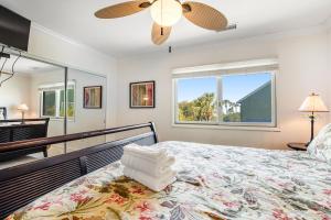 a bedroom with a large bed and a window at Mariner's Walk 8-A in Isle of Palms