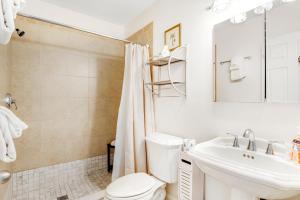 a bathroom with a toilet and a sink and a mirror at Mariner's Walk 8-A in Isle of Palms +27 photos