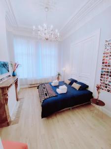 a bedroom with a large bed and a piano at CoCo Romantic - apartment in most trendy central hotspot of Antwerp in Antwerp