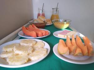 a table with plates of food on a table at Pousada Princesa do Agreste in Passa e Fica