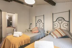 Postel nebo postele na pokoji v ubytování Palazzo Roselli Cecconi Apartments