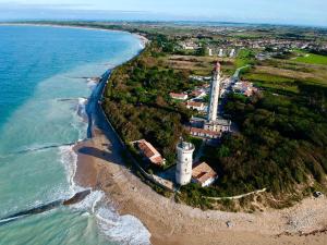 an island with a lighthouse next to the ocean at Ma Chambre d'Amis in Saint-Clément-des-Baleines