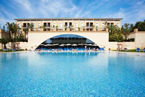 einem großen Pool vor einem Gebäude in der Unterkunft Grupotel Playa de Palma Suites & Spa in Playa de Palma