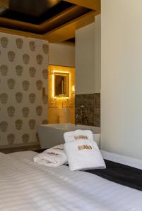 a bedroom with a bed and a tub and towels at HIDDEN BANK: First Million in Plovdiv +91 photos