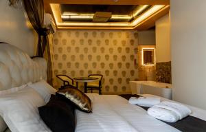 a bedroom with a bed and a table and a tub at HIDDEN BANK: First Million in Plovdiv