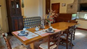 a wooden table with chairs and a dining room at Borgo La Civitella in Roccastrada