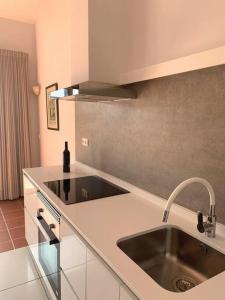 a kitchen with a sink and a counter top at TOP BEACH HOUSE in Costa da Caparica